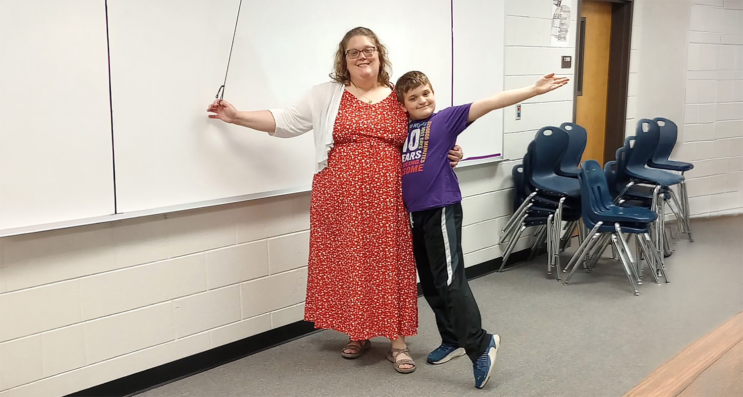 Amanda Ashour and her son stand at the head of her classroom.